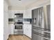 Modern kitchen with stainless steel appliances and white cabinetry at 88 Oakland Hills Pl, Rotonda West, FL 33947