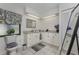 Well-lit bathroom with granite countertops, ample cabinet space, decorative mirror, and window at 10127 Peach Ave, Englewood, FL 34224