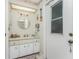 Bathroom with vanity, mirror, and exterior access at 10127 Peach Ave, Englewood, FL 34224