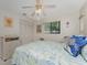 Comfortable bedroom with wicker furniture, closet, ceiling fan and a sun-filled window at 10127 Peach Ave, Englewood, FL 34224