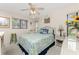 Cozy bedroom featuring wicker furniture, ceiling fan, and bright, sun-filled windows at 10127 Peach Ave, Englewood, FL 34224