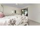 Bright bedroom with neutral walls, ceiling fan, and sliding glass doors leading to outdoor pool at 10127 Peach Ave, Englewood, FL 34224