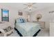Bright bedroom with a ceiling fan and comfortable bedding at 10127 Peach Ave, Englewood, FL 34224