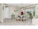 Casual dining area with a glass-top table and wicker chairs at 10127 Peach Ave, Englewood, FL 34224