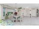 Bright dining area with a glass-top table and window views at 10127 Peach Ave, Englewood, FL 34224