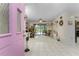 Inviting entryway with pink door opening to a view of the living area at 10127 Peach Ave, Englewood, FL 34224