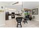 Eat-in kitchen with breakfast bar, white cabinetry, and view of the pool at 10127 Peach Ave, Englewood, FL 34224