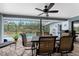 Screened lanai with dining set overlooking a private swimming pool and lush backyard at 10127 Peach Ave, Englewood, FL 34224
