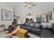 Spacious living room with a large sectional couch open to kitchen and backyard at 10127 Peach Ave, Englewood, FL 34224