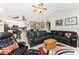 Inviting living room with a large sectional couch open to kitchen and backyard at 10127 Peach Ave, Englewood, FL 34224