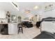 Spacious living room with black leather sofas and a view of the kitchen at 10127 Peach Ave, Englewood, FL 34224