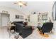 Cozy living room with tile floors and large windows providing lots of natural light at 10127 Peach Ave, Englewood, FL 34224