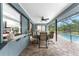 Covered patio with pool view, dining area, and ceiling fan at 10127 Peach Ave, Englewood, FL 34224