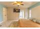 Bright bedroom with tiled floors, a ceiling fan, and a large tan bed at 10413 Grail Ave, Englewood, FL 34224