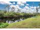 Serene view of a canal with lush greenery and a small boat at 11743 Claremont Dr, Port Charlotte, FL 33981