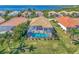 Aerial view of home with private pool and screened enclosure at 12960 N Marsh Dr, Port Charlotte, FL 33953