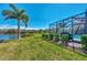 Landscaped backyard with pool and lake view at 12960 N Marsh Dr, Port Charlotte, FL 33953