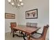 Bright dining room with a wooden table and chairs, complemented by elegant light fixture at 12960 N Marsh Dr, Port Charlotte, FL 33953
