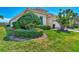 Landscaped yard with lush greenery and manicured bushes at 12960 N Marsh Dr, Port Charlotte, FL 33953