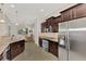 Kitchen with stainless steel appliances and dark wood cabinetry at 12960 N Marsh Dr, Port Charlotte, FL 33953
