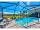 Relaxing pool area with covered lanai and lake view at 12960 N Marsh Dr, Port Charlotte, FL 33953
