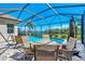 Screened pool and patio furniture with lake view at 12960 N Marsh Dr, Port Charlotte, FL 33953