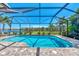 Inviting screened pool and lanai overlooking a tranquil lake at 12960 N Marsh Dr, Port Charlotte, FL 33953