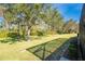Landscaped backyard with mature trees and grassy area at 13488 Abercrombie Dr, Englewood, FL 34223