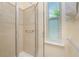 Clean bathroom with shower and window at 13488 Abercrombie Dr, Englewood, FL 34223