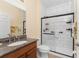 Updated bathroom with a walk-in shower and granite vanity at 13488 Abercrombie Dr, Englewood, FL 34223