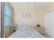 Well-lit bedroom with a full-size bed and window views at 13488 Abercrombie Dr, Englewood, FL 34223
