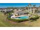 Community pool, spa, and clubhouse with palm trees at 13488 Abercrombie Dr, Englewood, FL 34223
