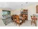 Combined dining and living room with tiled floors and access to patio at 13488 Abercrombie Dr, Englewood, FL 34223