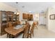 Dining room adjacent to kitchen, features wood table and chairs at 13488 Abercrombie Dr, Englewood, FL 34223