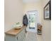Entryway with a wooden console table, coat rack, and decorative door at 13488 Abercrombie Dr, Englewood, FL 34223