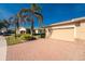 House exterior with a two-car garage and well-maintained landscaping at 13488 Abercrombie Dr, Englewood, FL 34223