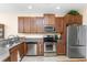 Kitchen with wood cabinets, granite counters, and a double sink at 13488 Abercrombie Dr, Englewood, FL 34223