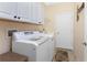 Laundry room with washer, dryer, and overhead cabinets at 13488 Abercrombie Dr, Englewood, FL 34223