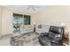 Bright living room with comfy seating and view to backyard at 13488 Abercrombie Dr, Englewood, FL 34223