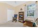 Spacious home office with a rocking chair and large window at 13488 Abercrombie Dr, Englewood, FL 34223