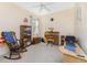 Home office with a rocking chair, desk, and built-in shelving at 13488 Abercrombie Dr, Englewood, FL 34223