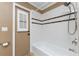 Bathroom with shower/tub combo and a door leading to the backyard at 13694 Begonia Cir, Port Charlotte, FL 33981