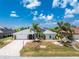 Single-story home with a two-car garage and mature landscaping at 13694 Begonia Cir, Port Charlotte, FL 33981