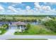 Aerial view of a waterfront home with a large backyard and a golf course nearby at 13962 Orbit Ave, Port Charlotte, FL 33981