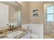 Small bathroom with granite countertop, walk-in shower, and shiplap walls at 13962 Orbit Ave, Port Charlotte, FL 33981