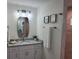 Bathroom with granite vanity, updated lighting, and shower at 14331 Montmarte Ave, Port Charlotte, FL 33981