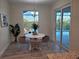 Breakfast nook with pool view and modern chandelier at 14331 Montmarte Ave, Port Charlotte, FL 33981