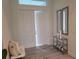 Bright entryway with tile flooring, a bench, and two mirrors at 14331 Montmarte Ave, Port Charlotte, FL 33981