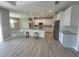 Modern, open-concept kitchen boasts stainless appliances, island with bar seating and an adjacent dining area at 14331 Montmarte Ave, Port Charlotte, FL 33981