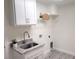 Laundry room with a utility sink and overhead shelving at 14331 Montmarte Ave, Port Charlotte, FL 33981